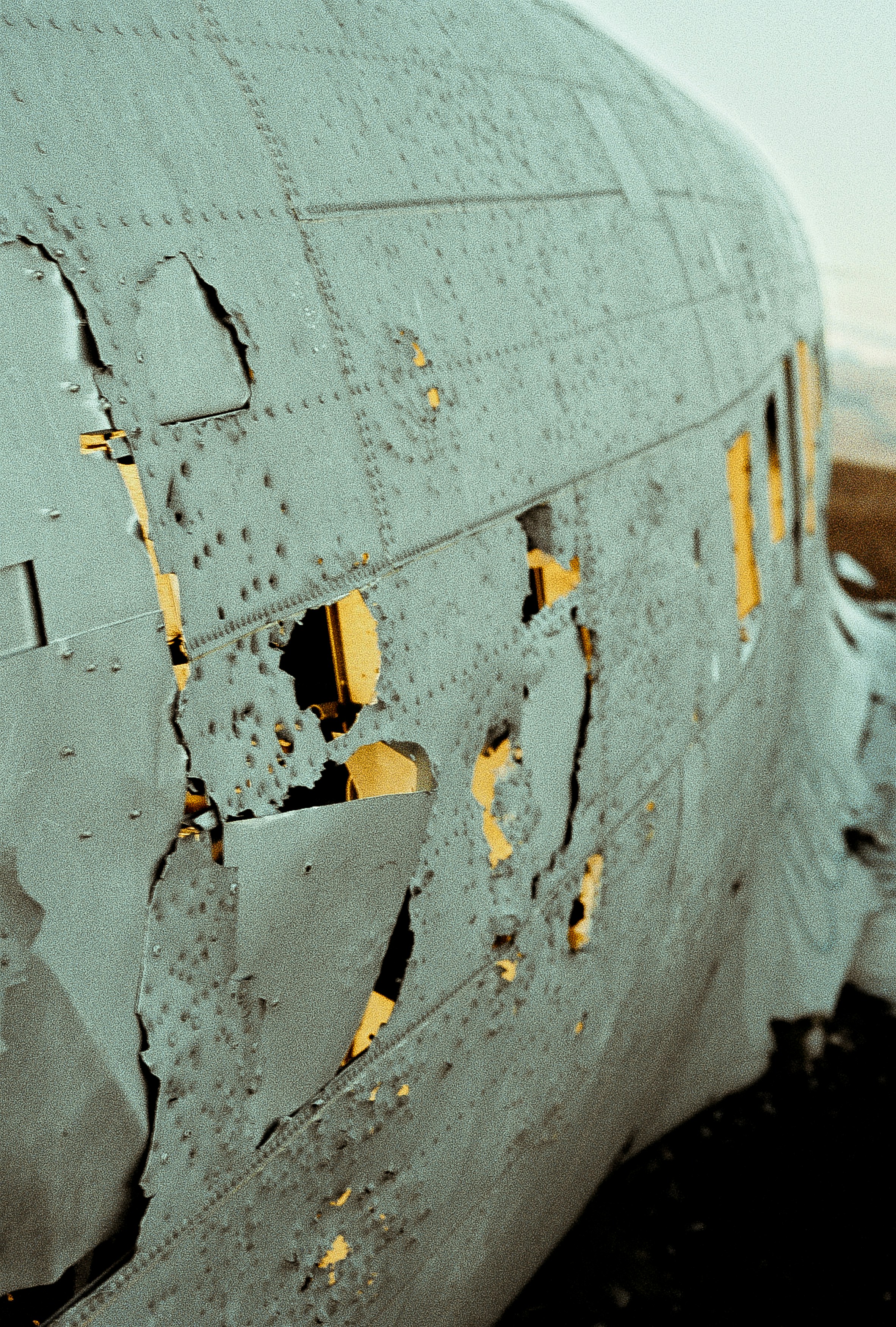 Abandoned aircraft fuselage in muted light, the post-incident site where the flight recorder is the only evidence that survives